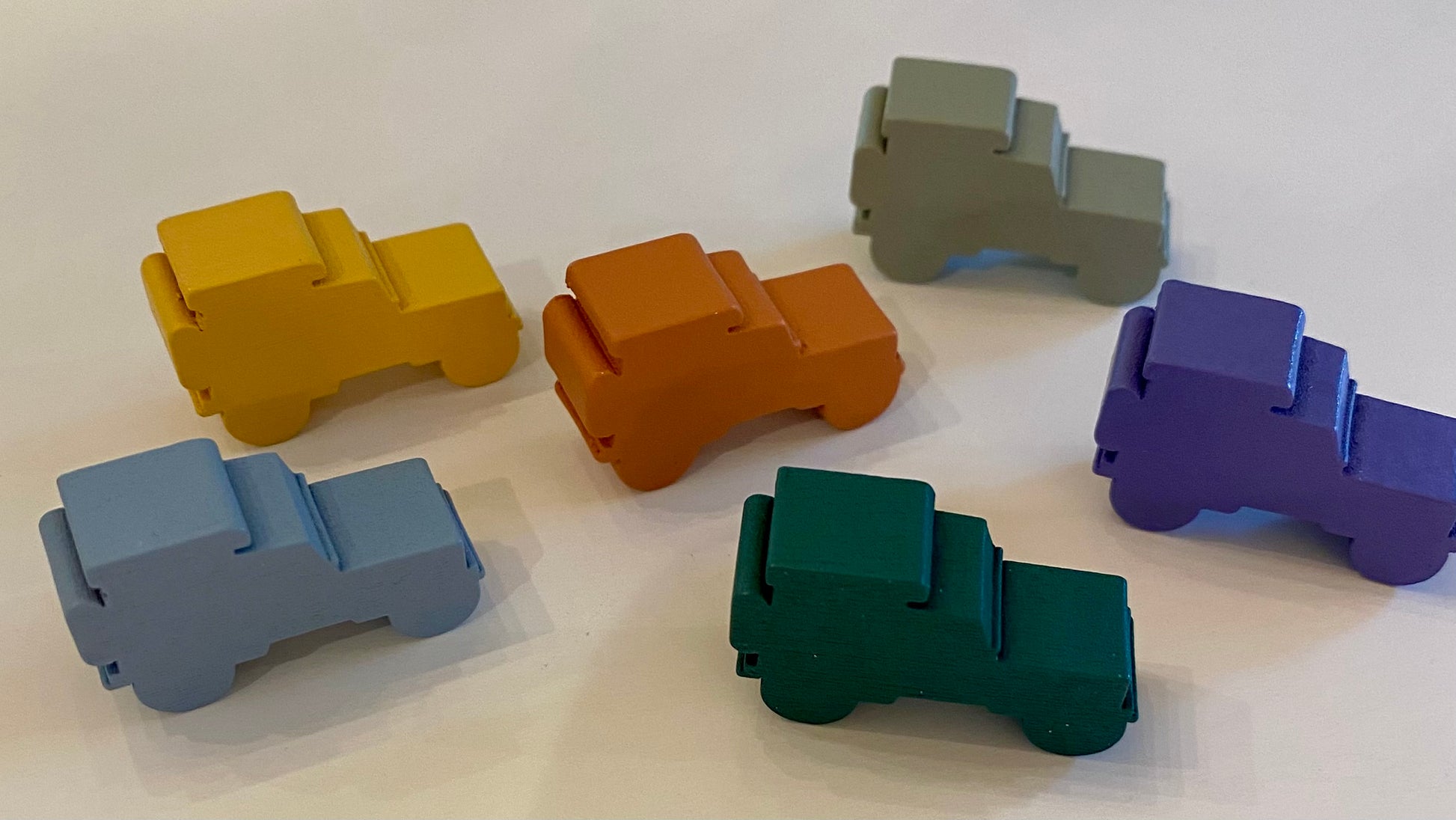 Set of colorful wooden jeeples on a white background