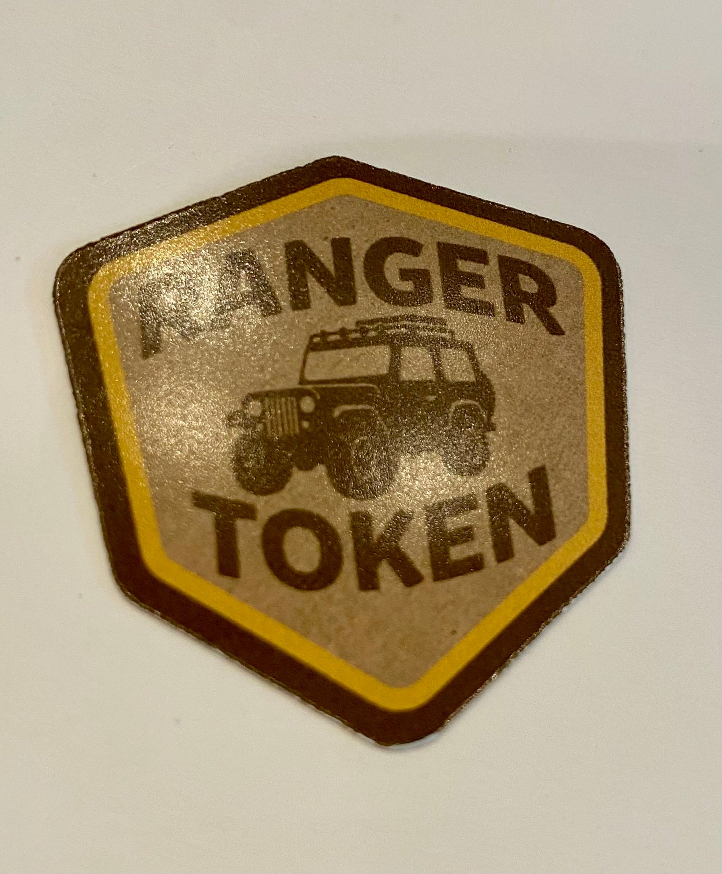 Hexagonal 'Ranger Token' badge with a jeeple illustration on a white background