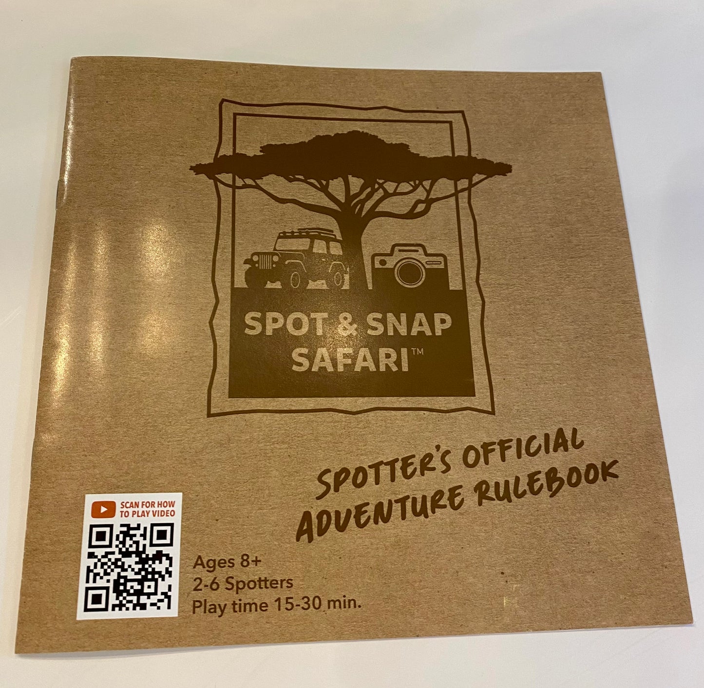 Brown book titled 'Spot & Snap Safari' with a QR code on a white background