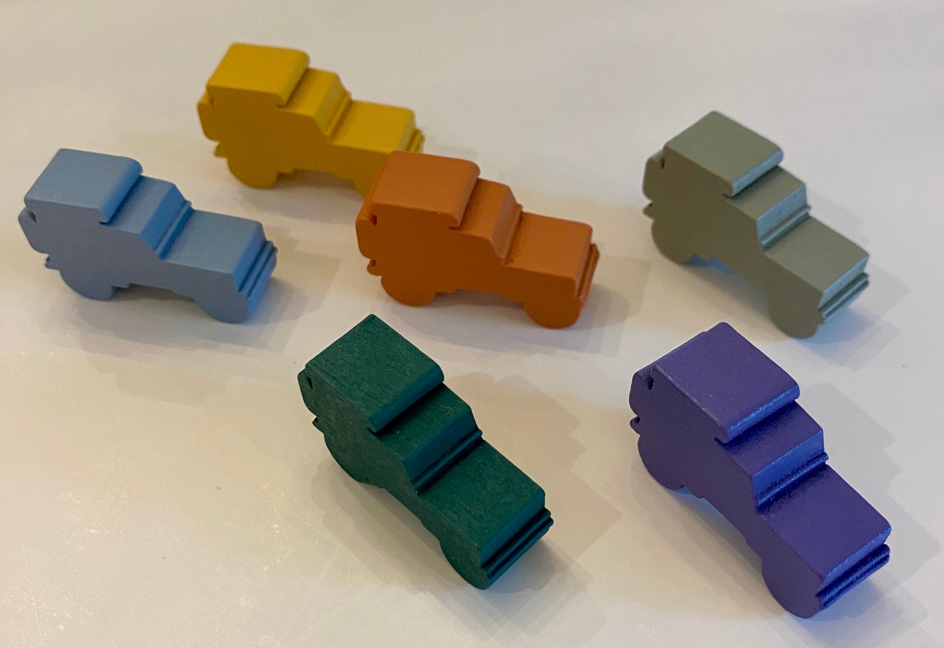 Colorful wooden jeeples on a white background
